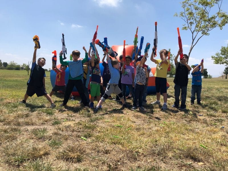 Group of kids participating in a Nerf Gun Party in Cypress, Orange County California. They chose to use Mega Nerf Guns to color coordinate with the nerf arena that we provided for the birthday boy.