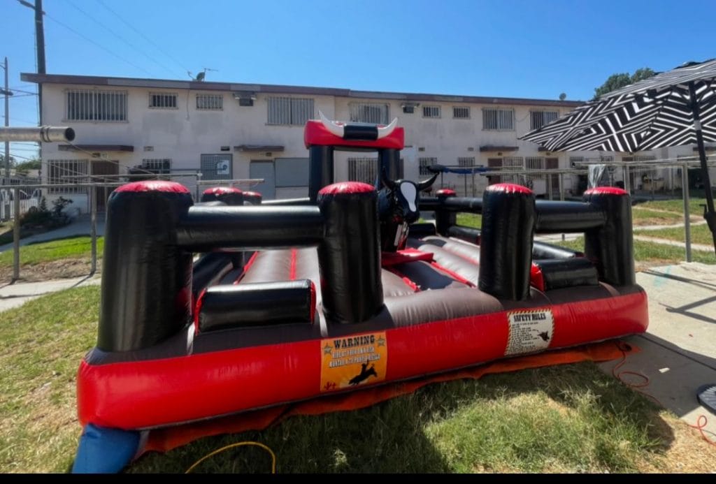 Our second mechanical bull that we just introduced to residents of Santa Ana, Orange, Anaheim, and Huntington Beach. This bull rental comes with a red and black inflatable and a large premier bull that's ideal for adults.